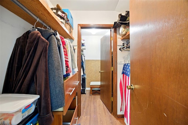 walk in closet with wood finished floors