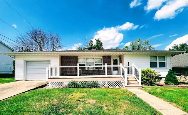 view of front of home featuring a porch, an attached garage, a front yard, and driveway