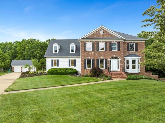 214 Townview Ct, Wentzville, MO 63385 - georgian-style home with brick siding, a front lawn, and an outbuilding