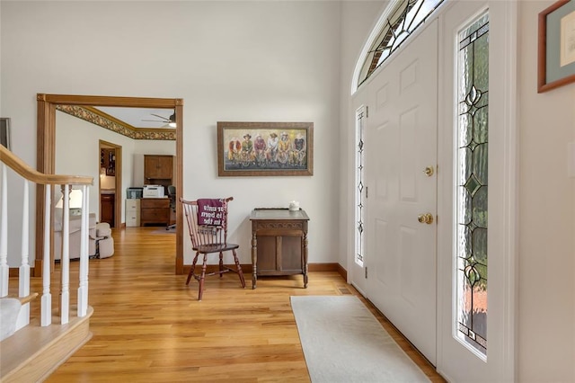 214 Townview Ct, Wentzville, MO 63385 - entrance foyer featuring stairs, light wood-type flooring, ceiling fan, and baseboards