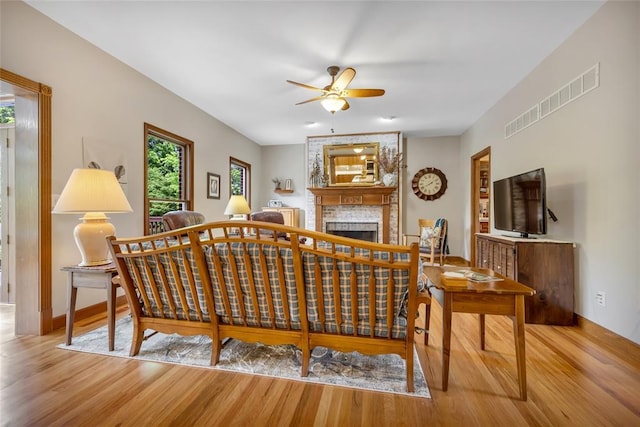 214 Townview Ct, Wentzville, MO 63385 - living room featuring wood finished floors, ceiling fan, a fireplace, and baseboards