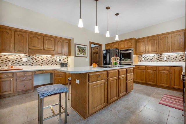 214 Townview Ct, Wentzville, MO 63385 - kitchen featuring black appliances, brown cabinets, and tasteful backsplash