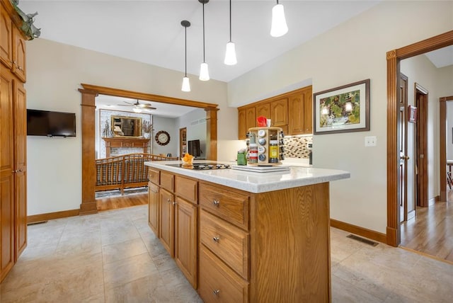 214 Townview Ct, Wentzville, MO 63385 - kitchen with light countertops, decorative backsplash, ceiling fan, baseboards, and black electric cooktop