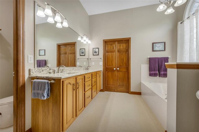214 Townview Ct, Wentzville, MO 63385 - full bath featuring a bath, a chandelier, double vanity, and toilet