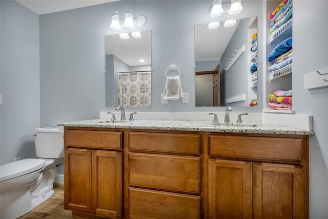 214 Townview Ct, Wentzville, MO 63385 - bathroom featuring toilet, wood finished floors, and double vanity