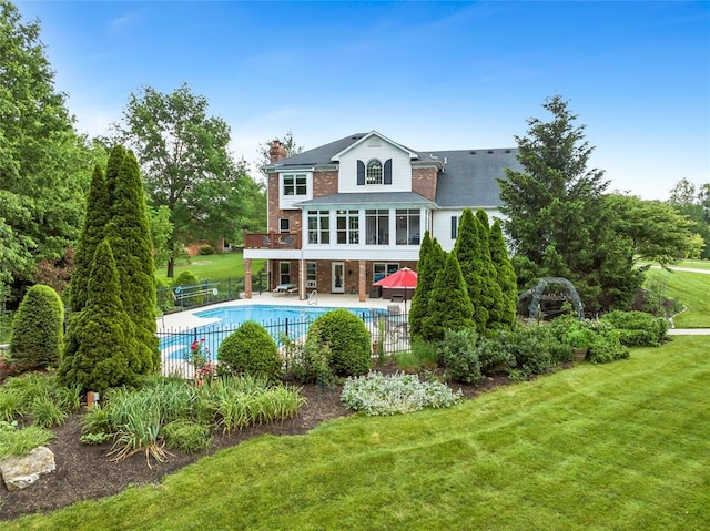 214 Townview Ct, Wentzville, MO 63385 - back of property featuring a chimney, a patio area, brick siding, a sunroom, and roof with shingles