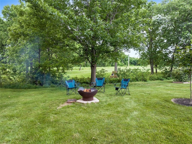 214 Townview Ct, Wentzville, MO 63385 - view of grassy yard with an outdoor fire pit