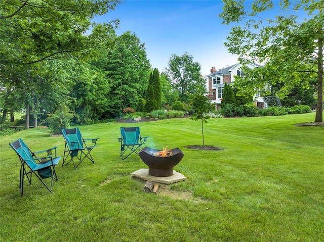 214 Townview Ct, Wentzville, MO 63385 - view of grassy yard with an outdoor fire pit