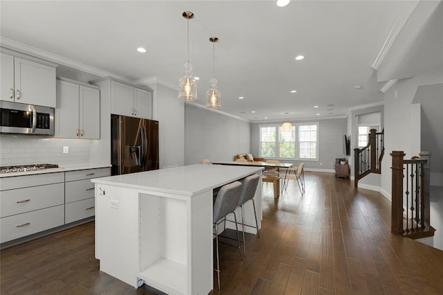 8000 Central Park Dr, Richmond Heights, MO 63117 - kitchen with stainless steel appliances, crown molding, recessed lighting, backsplash, and a kitchen island