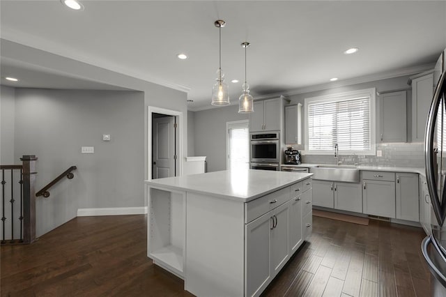 8000 Central Park Dr, Richmond Heights, MO 63117 - kitchen with a sink, backsplash, light countertops, a kitchen island, and recessed lighting