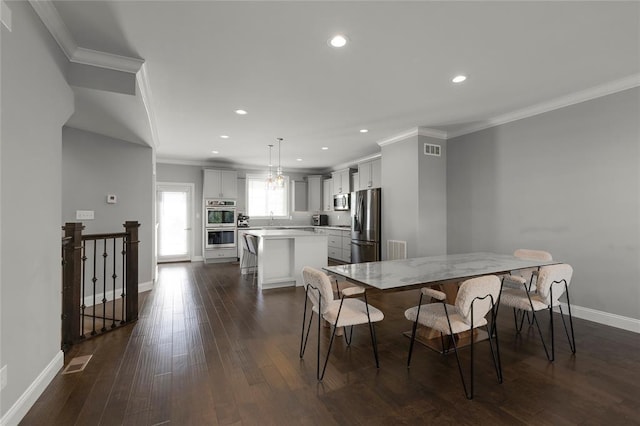 8000 Central Park Dr, Richmond Heights, MO 63117 - dining space featuring dark wood finished floors, crown molding, recessed lighting, and baseboards