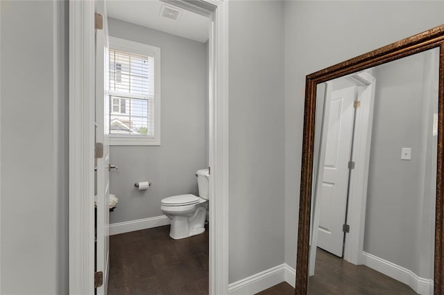 8000 Central Park Dr, Richmond Heights, MO 63117 - bathroom featuring toilet, baseboards, and wood finished floors