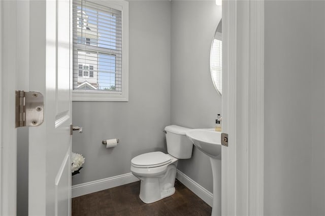 8000 Central Park Dr, Richmond Heights, MO 63117 - half bathroom featuring baseboards, toilet, and wood finished floors