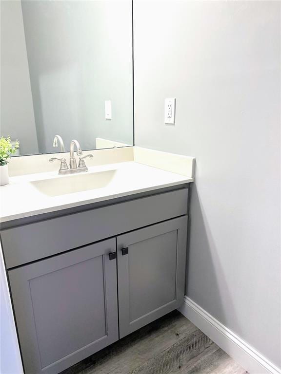 207 Still Creek Dr, Lake St Louis, MO 63367 - bathroom featuring wood finished floors, vanity, and baseboards
