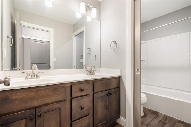207 Still Creek Dr, Lake St Louis, MO 63367 - full bathroom featuring wood finished floors, toilet, double vanity, and shower / bath combination