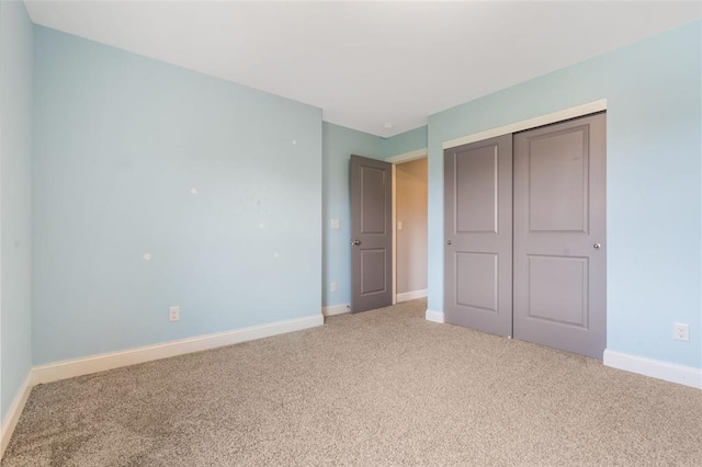 207 Still Creek Dr, Lake St Louis, MO 63367 - unfurnished bedroom with light carpet, baseboards, and a closet