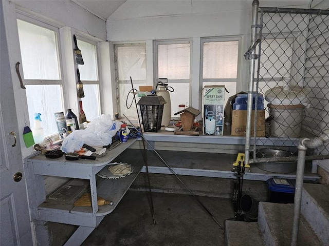 misc room with concrete floors and vaulted ceiling
