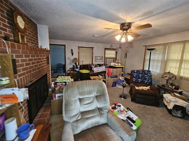 carpeted living area with a ceiling fan, a brick fireplace, and a textured ceiling