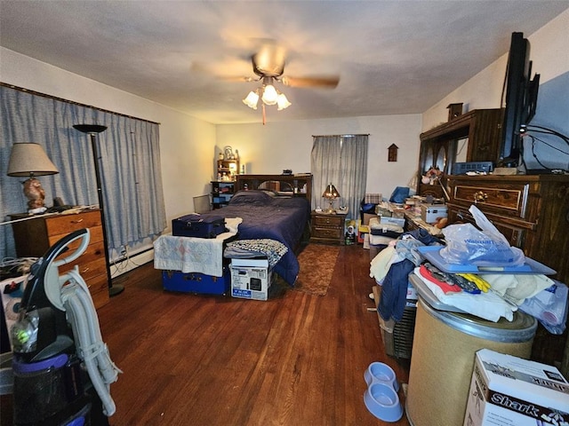 bedroom featuring wood finished floors, a baseboard heating unit, and a ceiling fan
