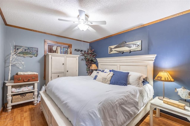 bedroom with wood finished floors, a textured ceiling, a ceiling fan, and ornamental molding