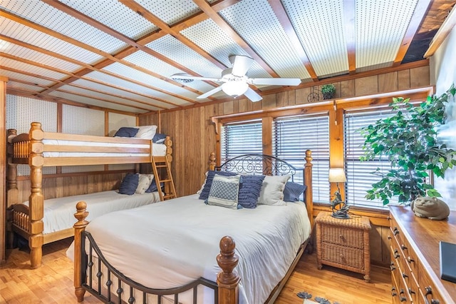 bedroom featuring wood finished floors and wood walls