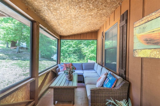 sunroom / solarium with an outdoor living space and lofted ceiling