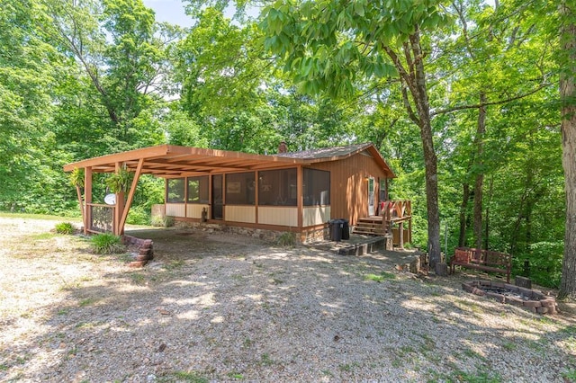 exterior space with gravel driveway and a carport