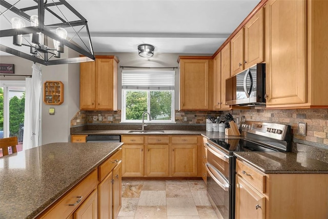 172 Snake River Dr, Dardenne Prairie, MO 63368 - kitchen with appliances with stainless steel finishes, a sink, tasteful backsplash, a chandelier, and dark stone counters