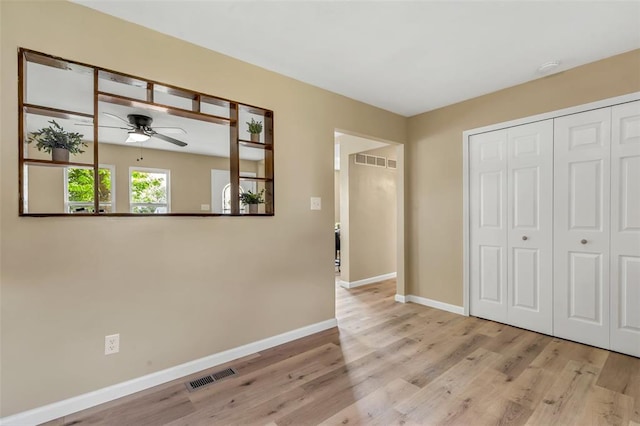 interior space with wood finished floors and baseboards