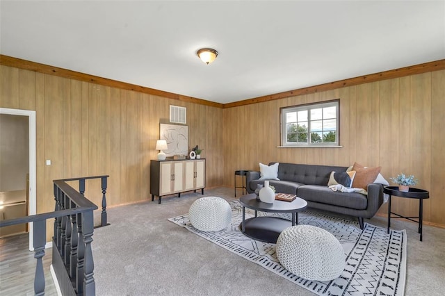 living room with wood walls and carpet floors