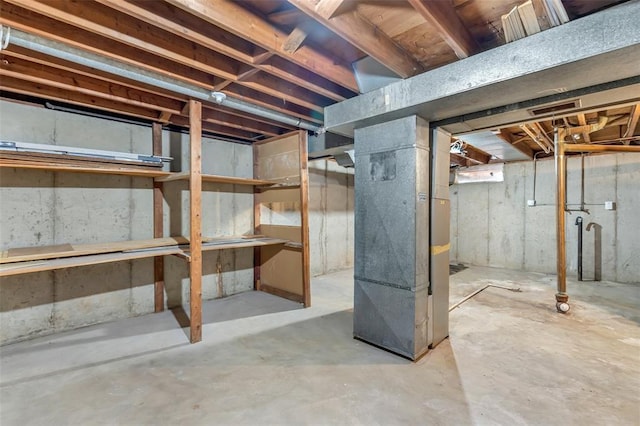 unfinished below grade area featuring heating unit