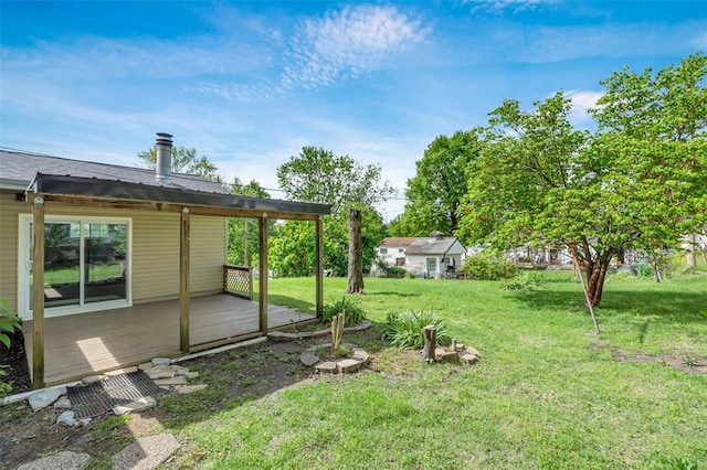 view of grassy yard featuring a deck