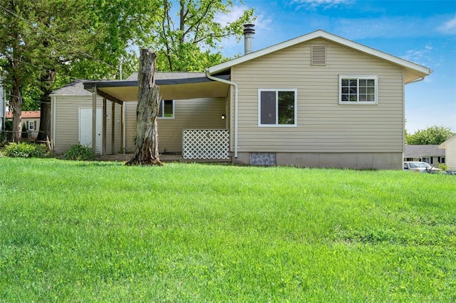 rear view of property with a lawn