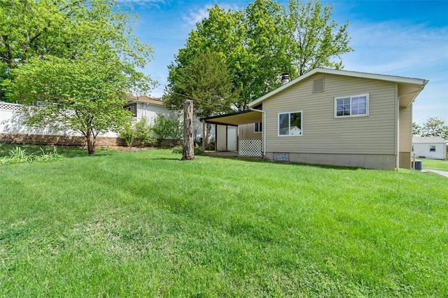 rear view of property featuring a lawn