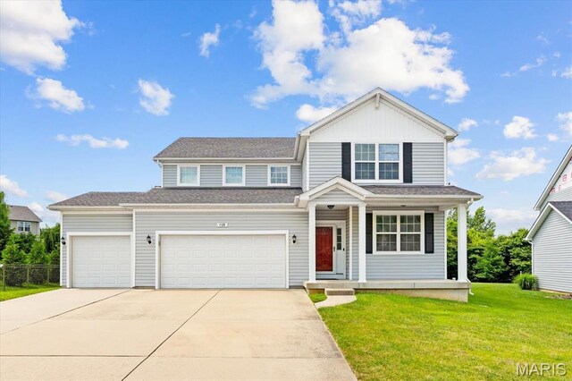 508 Frost Ct, Ofallon, IL 62269 - traditional home with driveway, a front lawn, a porch, and a garage