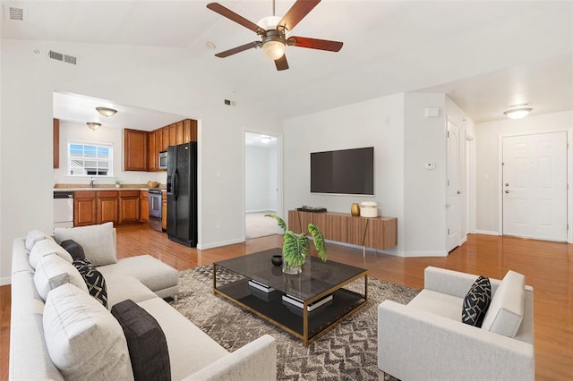 1131 Welsh Dr, Lake St Louis, MO 63367 - living room featuring a ceiling fan, baseboards, lofted ceiling, and light wood-style flooring