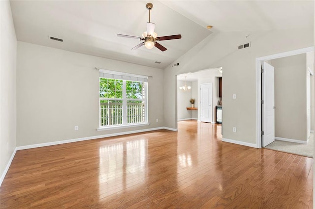 1131 Welsh Dr, Lake St Louis, MO 63367 - empty room featuring a chandelier, ceiling fan, light wood-style floors, vaulted ceiling, and baseboards