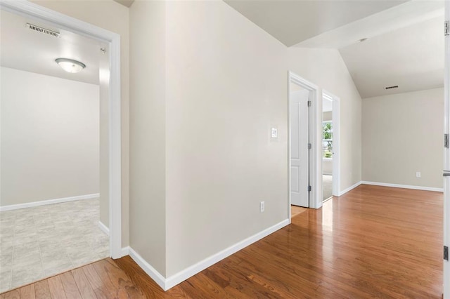 1131 Welsh Dr, Lake St Louis, MO 63367 - empty room with wood finished floors, baseboards, and lofted ceiling
