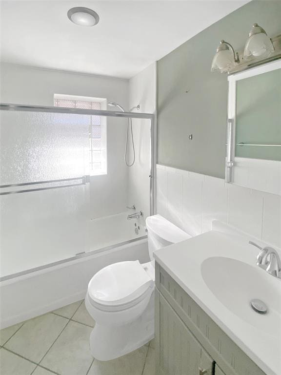 6504 Hoffman Ave, Saint Louis, MO 63139 - full bath featuring bath / shower combo with glass door, toilet, tile patterned flooring, and vanity