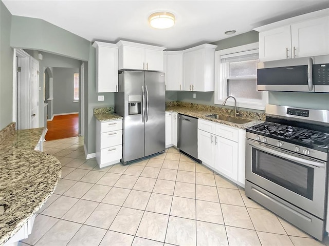 6504 Hoffman Ave, Saint Louis, MO 63139 - kitchen featuring stainless steel appliances, a sink, light stone countertops, and white cabinets