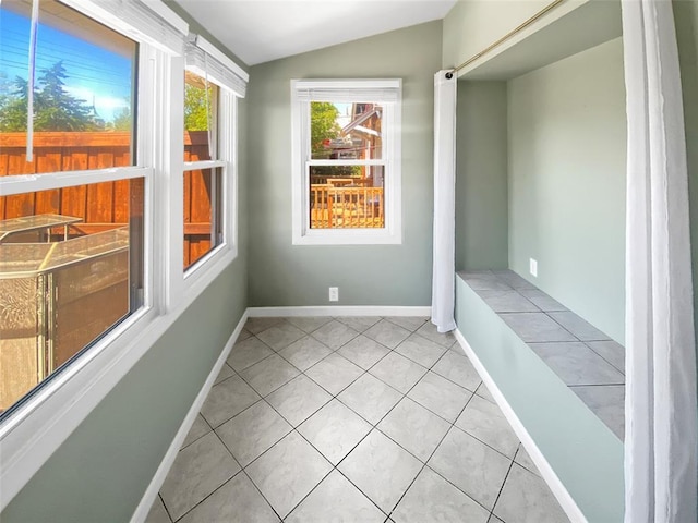6504 Hoffman Ave, Saint Louis, MO 63139 - spare room featuring lofted ceiling, light tile patterned floors, and baseboards