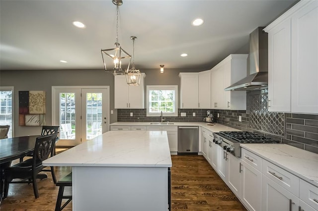 1026 Barry Ct, Kirkwood, MO 63122 - kitchen with wall chimney exhaust hood, stainless steel appliances, a sink, decorative backsplash, and a center island