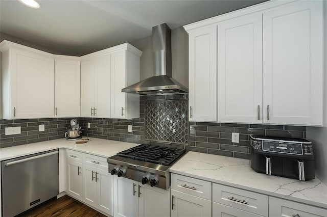 1026 Barry Ct, Kirkwood, MO 63122 - kitchen with stainless steel appliances, wall chimney range hood, white cabinetry, and decorative backsplash