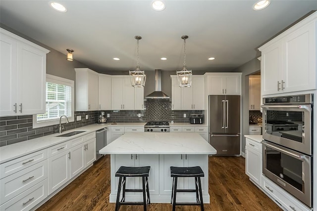 1026 Barry Ct, Kirkwood, MO 63122 - kitchen with appliances with stainless steel finishes, wall chimney range hood, a sink, white cabinets, and recessed lighting