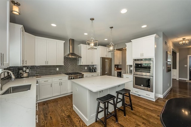 1026 Barry Ct, Kirkwood, MO 63122 - kitchen with wall chimney exhaust hood, a sink, stainless steel appliances, backsplash, and a center island