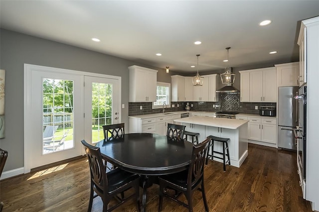1026 Barry Ct, Kirkwood, MO 63122 - dining space featuring dark wood-type flooring, recessed lighting, and baseboards