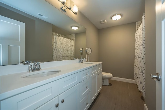 1026 Barry Ct, Kirkwood, MO 63122 - full bathroom featuring toilet, double vanity, and baseboards