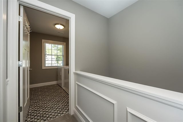 1026 Barry Ct, Kirkwood, MO 63122 - hallway featuring washer and dryer and baseboards