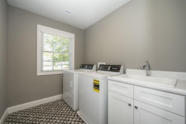 1026 Barry Ct, Kirkwood, MO 63122 - washroom featuring baseboards, washer and clothes dryer, and cabinet space