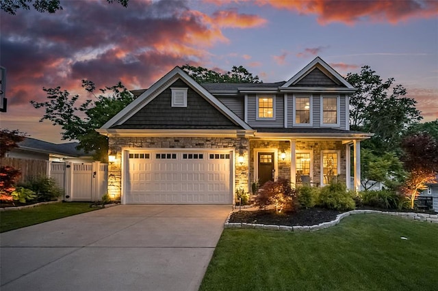 1026 Barry Ct, Kirkwood, MO 63122 - craftsman-style house featuring driveway, a garage, a porch, stone siding, and a gate